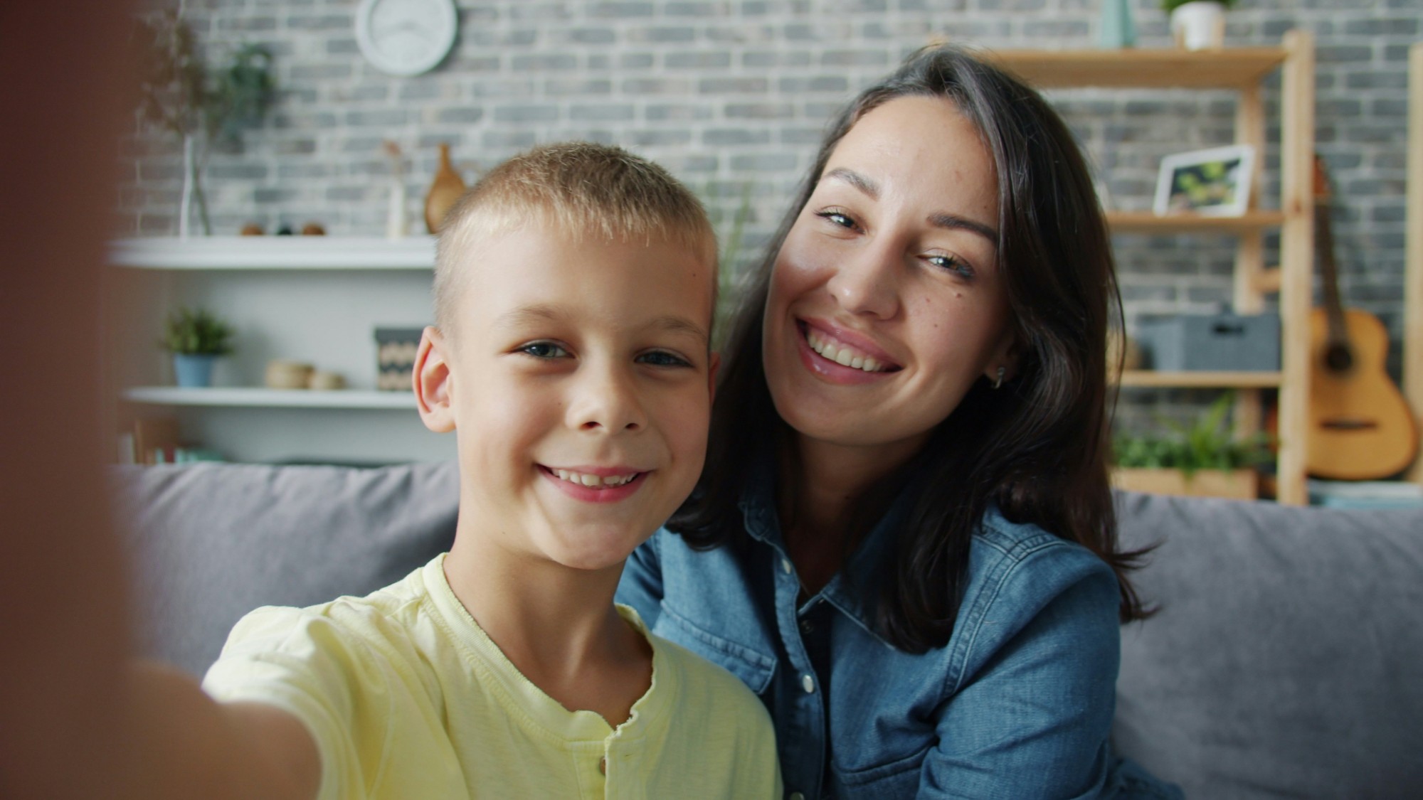 A parent and child smiling together at home